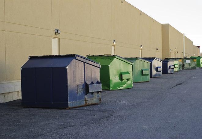 a construction worker moves construction materials near a dumpster in Lafayette, CA